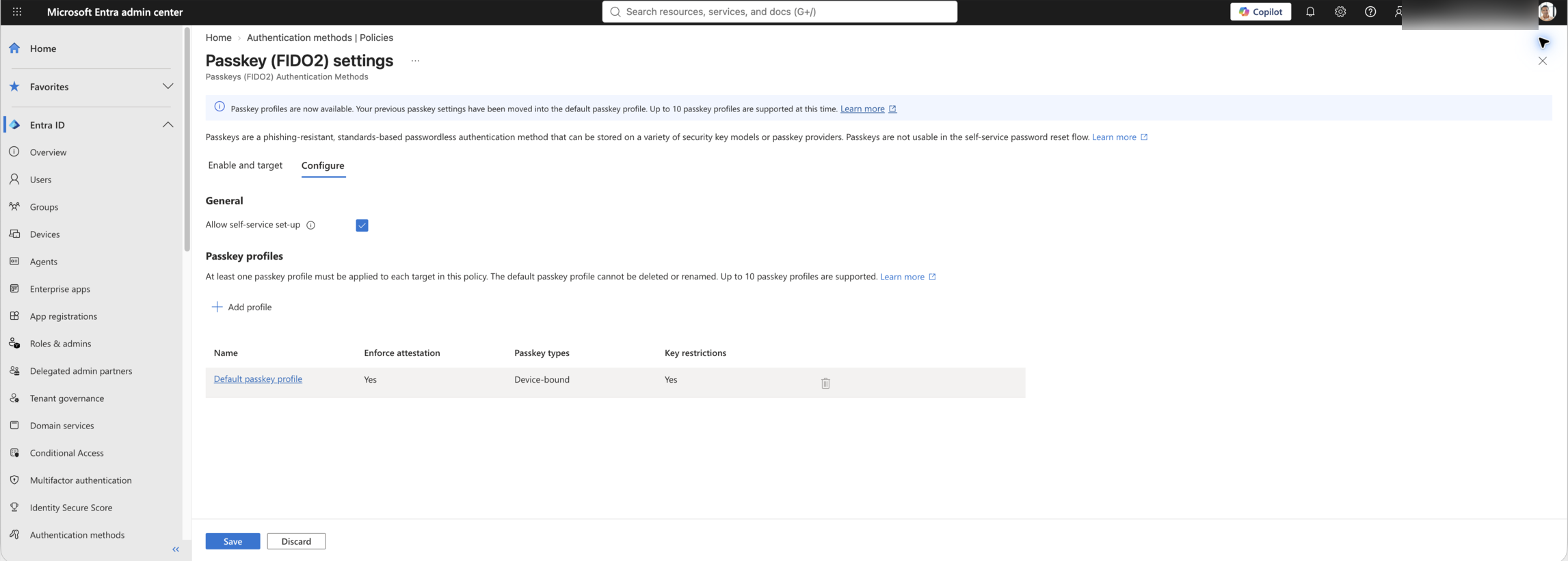 Live Microsoft Entra Passkey (FIDO2) Configure screen showing the default passkey profile and Key restrictions column.